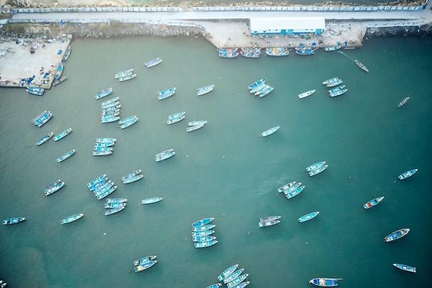 Aerial top view of fishing harbour with many traditional fisherman boats in kerala india