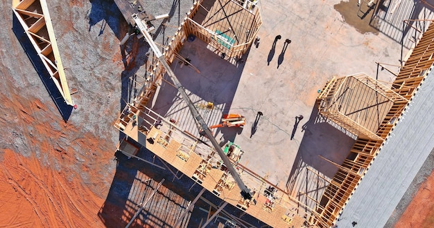 Aerial top view of installation of roof framing truss system wooden beams roofing construction