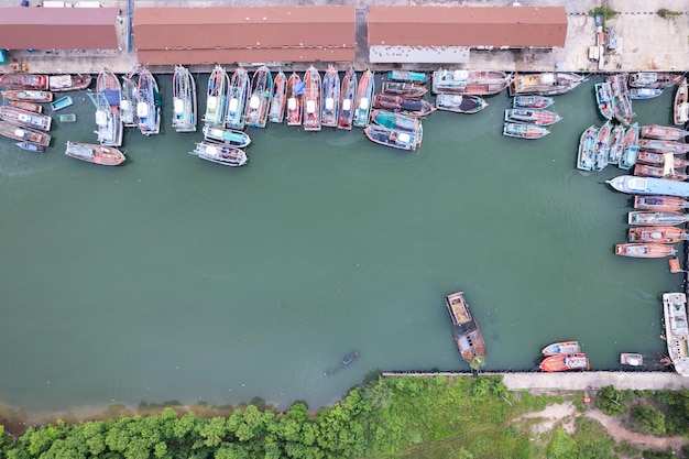 Aerial top view of the many fisherman boats with big fishing port at the pier in Phuket Thailand high angle view