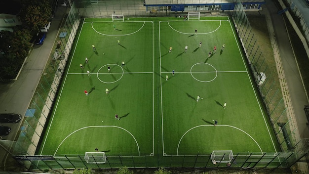 Aerial top view of a mini football match soccer MiniFootball field and Footballers from drone