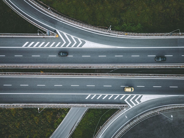 Aerial top view on road in city junction and city traffic cars on road