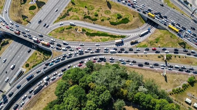 Aerial top view of road junction from above, automobile traffic and jam of many cars, transportation concept