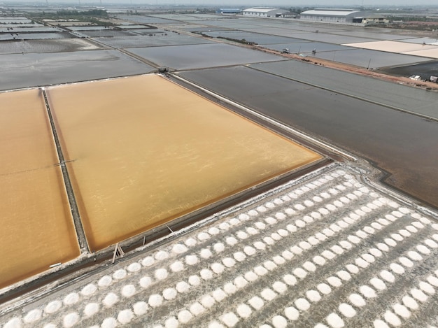 Aerial top view sea salt farm Pile of brine salt Raw material of salt industrial Sodium Chloride