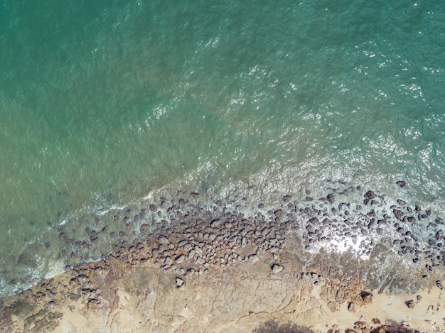 Aerial top view of sea waves and fantastic Rocky coast