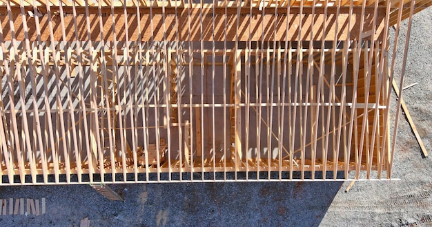 Aerial top view of shows the framing beams stick of a woodframed house under construction