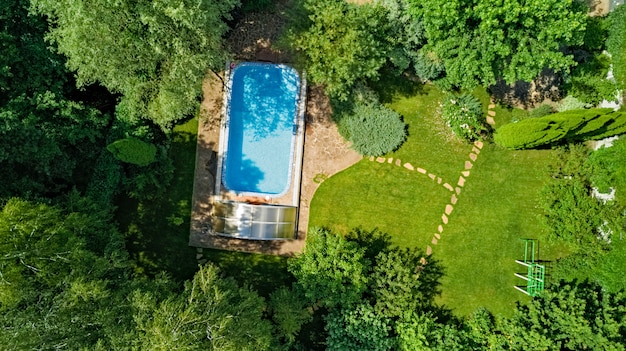 Aerial top view of swimming pool in beautiful garden