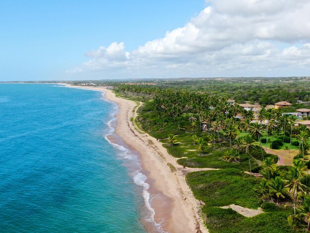 Aerial top view of tropical white sand beach and turquoise clear sea water with small waves