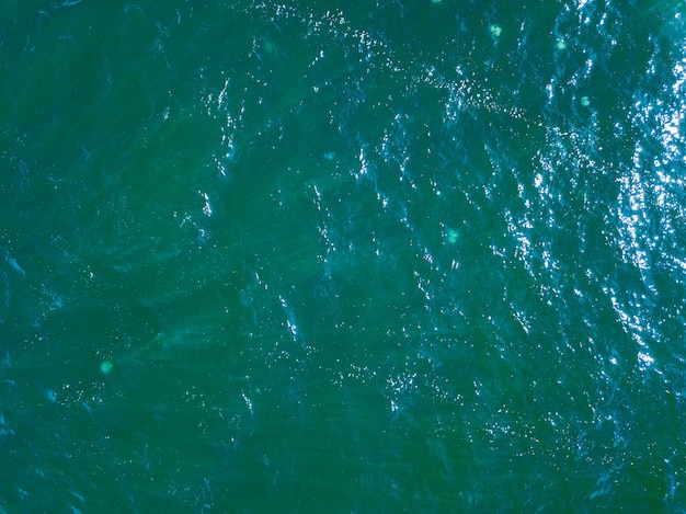 Aerial top view water surface background. Bird eye sea surface photo from drone. Blue ocean from above. Minimal natural background.