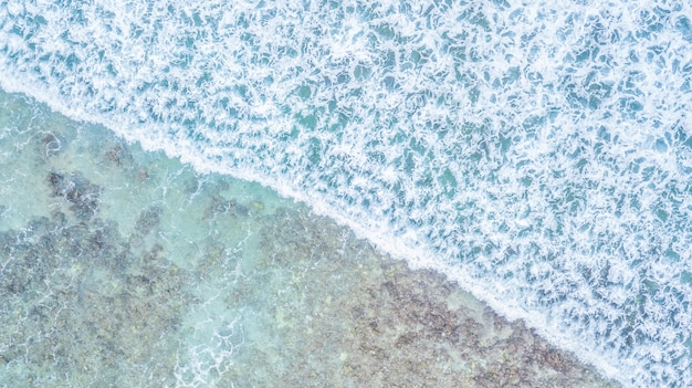 Aerial top view of waves ocean and coral reefs in Indean Ocean