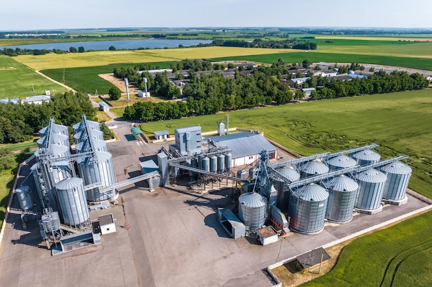 Aerial view on agro silos granary elevator on agroprocessing manufacturing plant for processing drying cleaning and storage of agricultural products flour cereals and grain