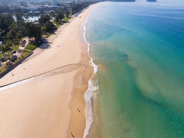 Aerial view of amazing beach with beautiful women walking on beach in sunset light close to turquoise seaTop view of summer beach landscapeHoliday Travel and tour concept