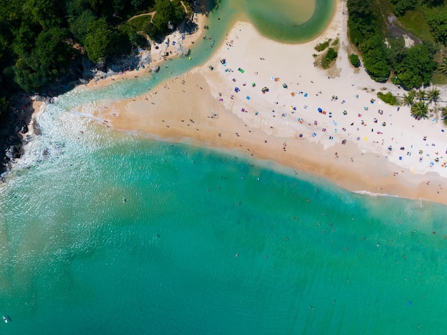 Aerial View Amazing beach with travel people relaxation on the beachBeautiful sea in summer season at Phuket island ThailandTravel people on beachBeach during summer with many resting people