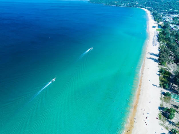 Aerial View Amazing beach with travel people relaxation on the beachBeautiful sea in summer season at Phuket island ThailandTravel people on beachBeach during summer with many resting people