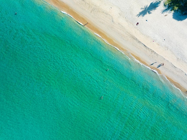 Aerial View Amazing beach with travel people relaxation on the beachBeautiful sea in summer season at Phuket island ThailandTravel people on beachBeach during summer with many resting people