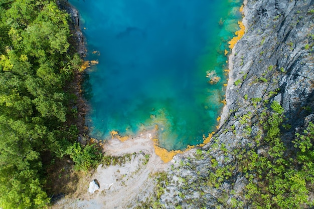 Aerial view of amazing pond in tropical rainforest forest with mountain rocks peak Beautiful water surface in Phang Nga Thailand