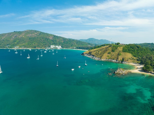 Aerial View Amazing sea with travel boatssailing boats in the seaBeautiful sea in summer season at Phuket island Thailand Travel boatsOcean during summer with many resting people