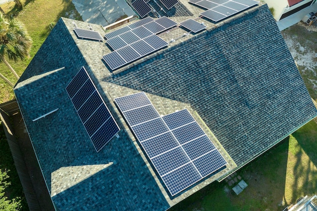 Aerial view of american building roof with blue solar photovoltaic panels for producing clean ecological electric energy Investing in renewable electricity for retirement income concept