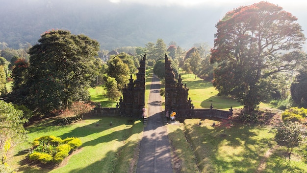 Aerial view of Ancient bali style gate with pathway in garden