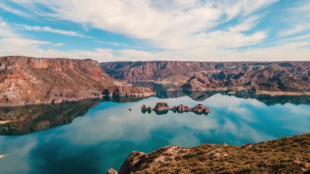 Aerial view of Atuel Canyon with cloudy sky reflection on the water, San Rafael, Mendoza, Argentina