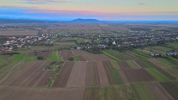 Aerial view on of autumn fields with countryside farmland huts around the little village beautiful l