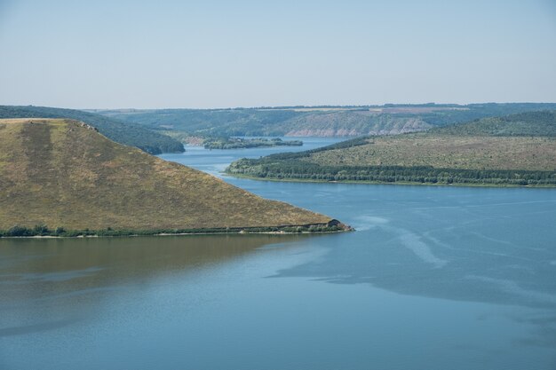 Aerial view to Bakota bay, Ukraine, scenic view to Dniester river, stones above the lake blue water, sunny day