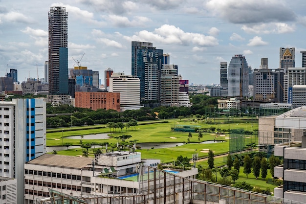 Aerial view of Bangkok cityscape in the morning showing highrises with a golf course