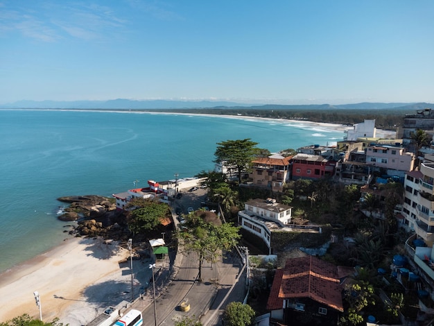 Aerial view of Barra de Guaratiba west zone of Rio de Janeiro Brazil Next to Marambaia beach Big hills around Sunny day at dawn Beach with clear water Barra de Guaratiba beach Drone photo