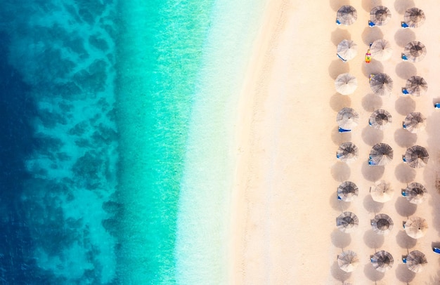 Aerial view on beach and umbrellas Vacation and adventure Top view from drone at beach and blue sea Croatia Travel and vacation image