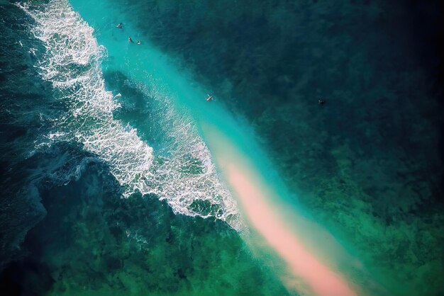 An aerial view of a beach with a green water and a beach in the background.