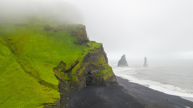 Aerial view of beautiful Famous Reynisdrangar rock formations at black Reynisfjara Beach, 