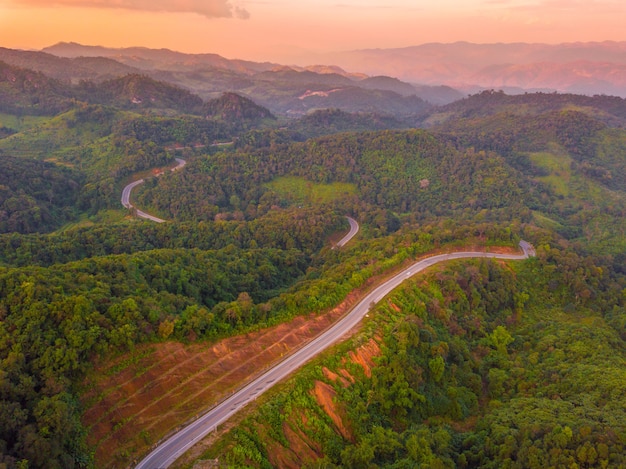 Aerial view of Beautiful road on the mountains in the evening sunset