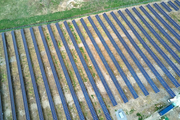 Aerial view of big sustainable electric power plant with many rows of solar photovoltaic panels for producing clean ecological electrical energy Renewable electricity with zero emission concept