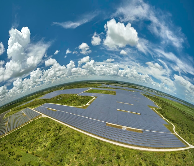 Aerial view of big sustainable electric power plant with many rows of solar photovoltaic panels for producing clean electrical energy Renewable electricity with zero emission concept