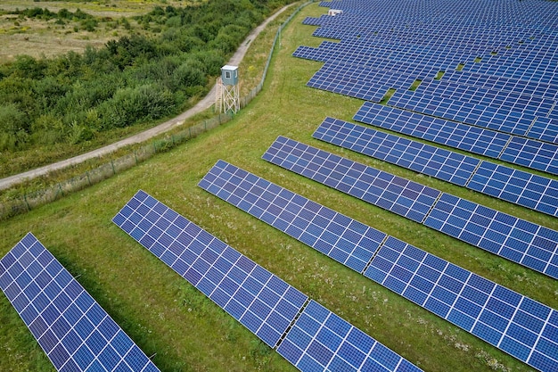 Aerial view of big sustainable electric power plant with many rows of solar photovoltaic panels for producing clean electrical energy Renewable electricity with zero emission concept