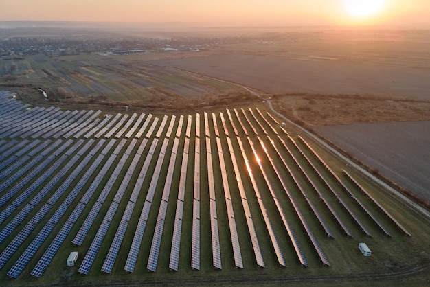 Aerial view of big sustainable electric power plant with many rows of solar photovoltaic panels for producing clean electrical energy at sunset Renewable electricity with zero emission concept