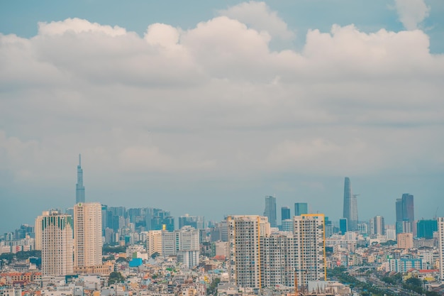 Aerial view of Bitexco Tower buildings roads Vo Van Kiet road in Ho Chi Minh city Far away is Landmark 81 skyscraper Travel concept