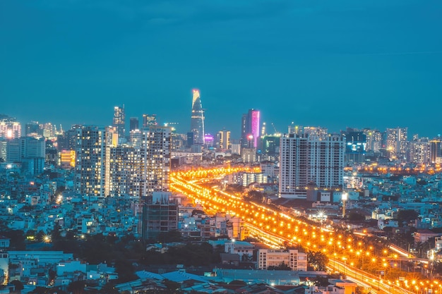 Aerial view of Bitexco Tower buildings roads Vo Van Kiet road in Ho Chi Minh city Far away is Landmark 81 skyscraper Travel concept