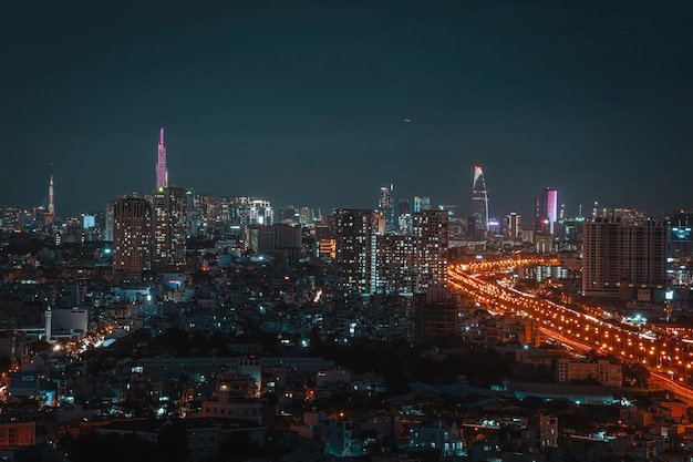 Aerial view of Bitexco Tower buildings roads Vo Van Kiet road in Ho Chi Minh city Far away is Landmark 81 skyscraper Travel concept