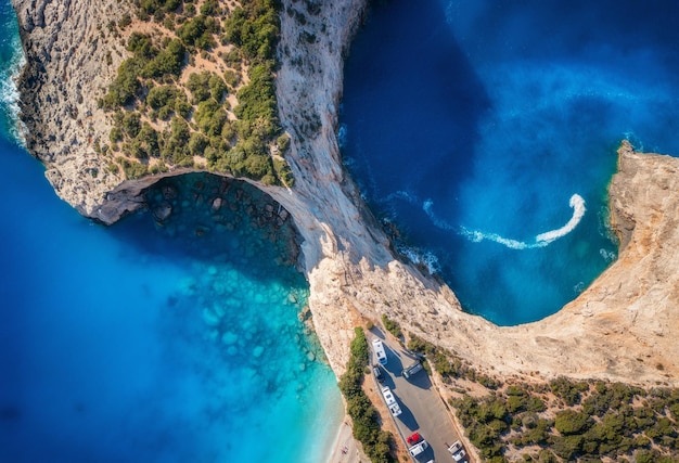 Aerial view of blue sea mountains white sandy beach at sunset in summer Porto Katsiki Lefkada island Greece Beautiful landscape with sea coast lagoon rocks azure water green forest Top view