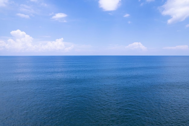 Aerial view of a blue sea surface water texture background and sun reflections Aerial flying drone view Waves water surface texture on sunny tropical ocean in Phuket island Thailand