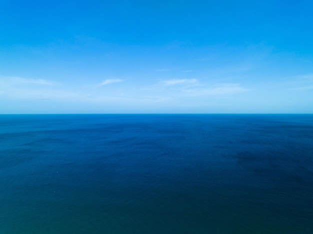 Aerial view of a blue sea surface water texture background and sun reflections Aerial flying drone view Waves water surface texture on sunny tropical ocean in Phuket island Thailand