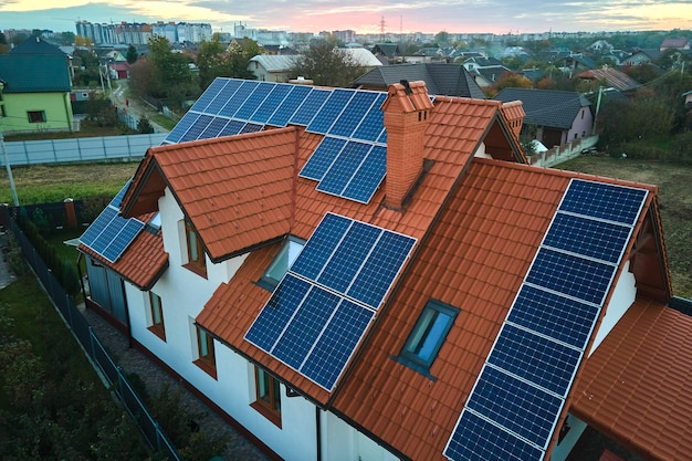 Aerial view building roof with rows of blue solar photovoltaic panels for producing clean ecological electric energy Renewable electricity with zero emission concept