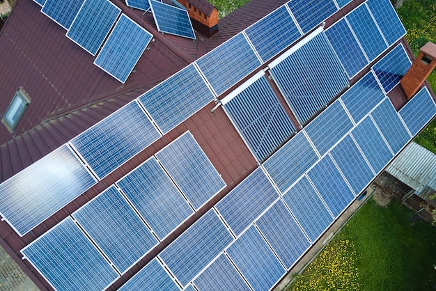 Aerial view building roof with rows of blue solar photovoltaic panels for producing clean ecological electric energy Renewable electricity with zero emission concept