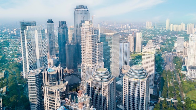 Aerial view of buildings in city against sky