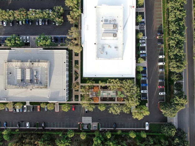 Aerial view of business and finance district with new office building surrounded by parking and road