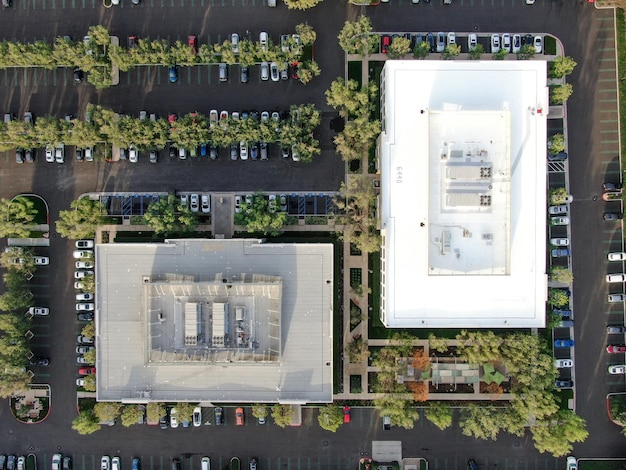 Aerial view of business and finance district with new office building surrounded by parking and road