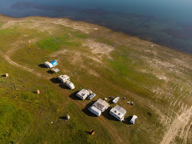 Aerial view of a campers van parked on a beach mountain range landscape