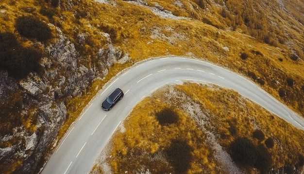 Aerial view of car and winding road in high mountain pass Serpentine curvy road