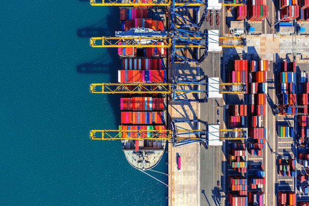 Aerial view of cargo ship and cargo container in harbor