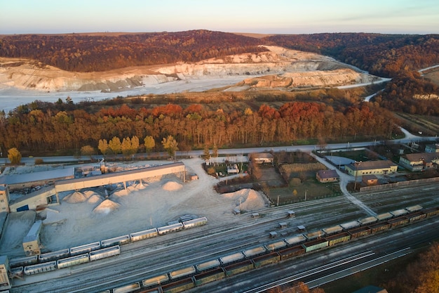 Aerial view of cargo train loaded with crushed stone materials at mining factory Railway transportation of grinded limestone ore